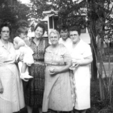 Gulfport, Harrison, Mississippi, USA Bama Smith Grayson, Tenderly Rose Bosworth held by Janie Morris Bosworth, Rosie S. Morris, Patsy Grayson Gendron and Helen Hoagland Bosworth Mason standing together on front yard of "Hungry Hill" at 1711 Wisteria Street.